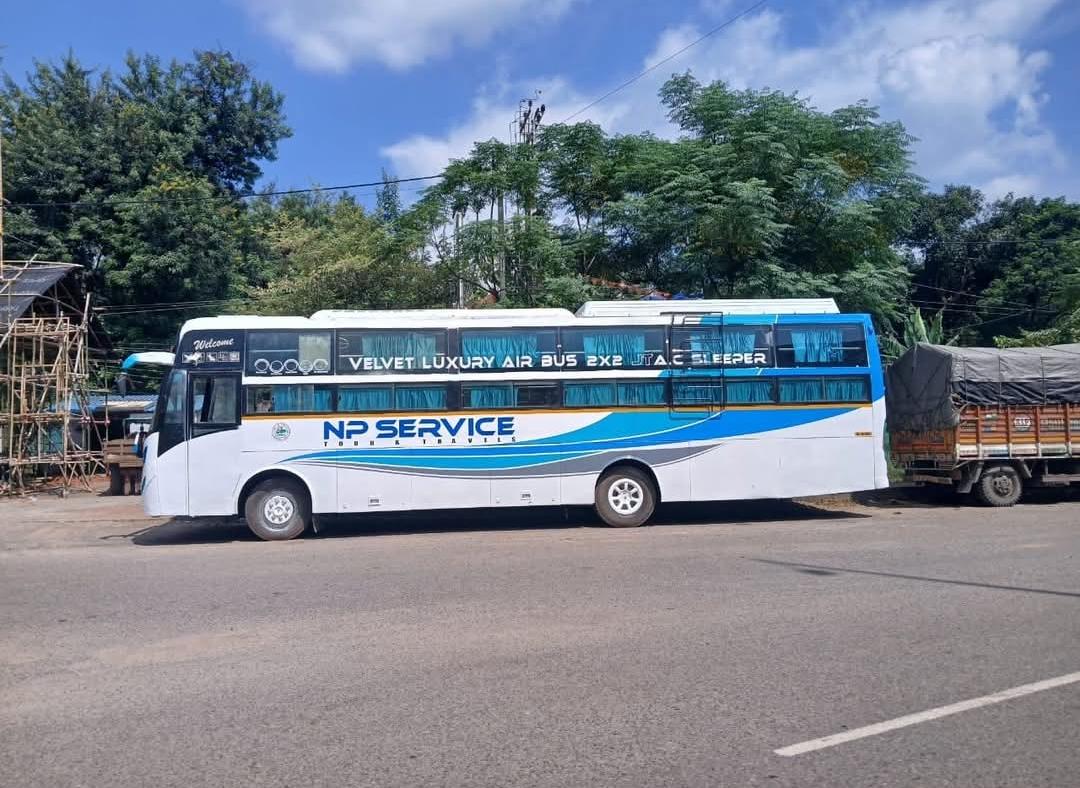 NP Service white and blue coach parked beside the road