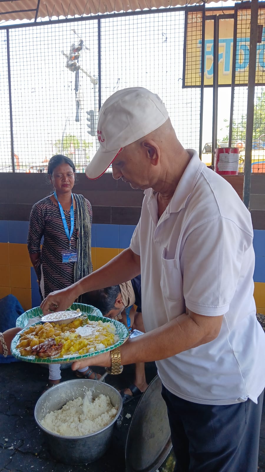 A member of the team serving a plate of food