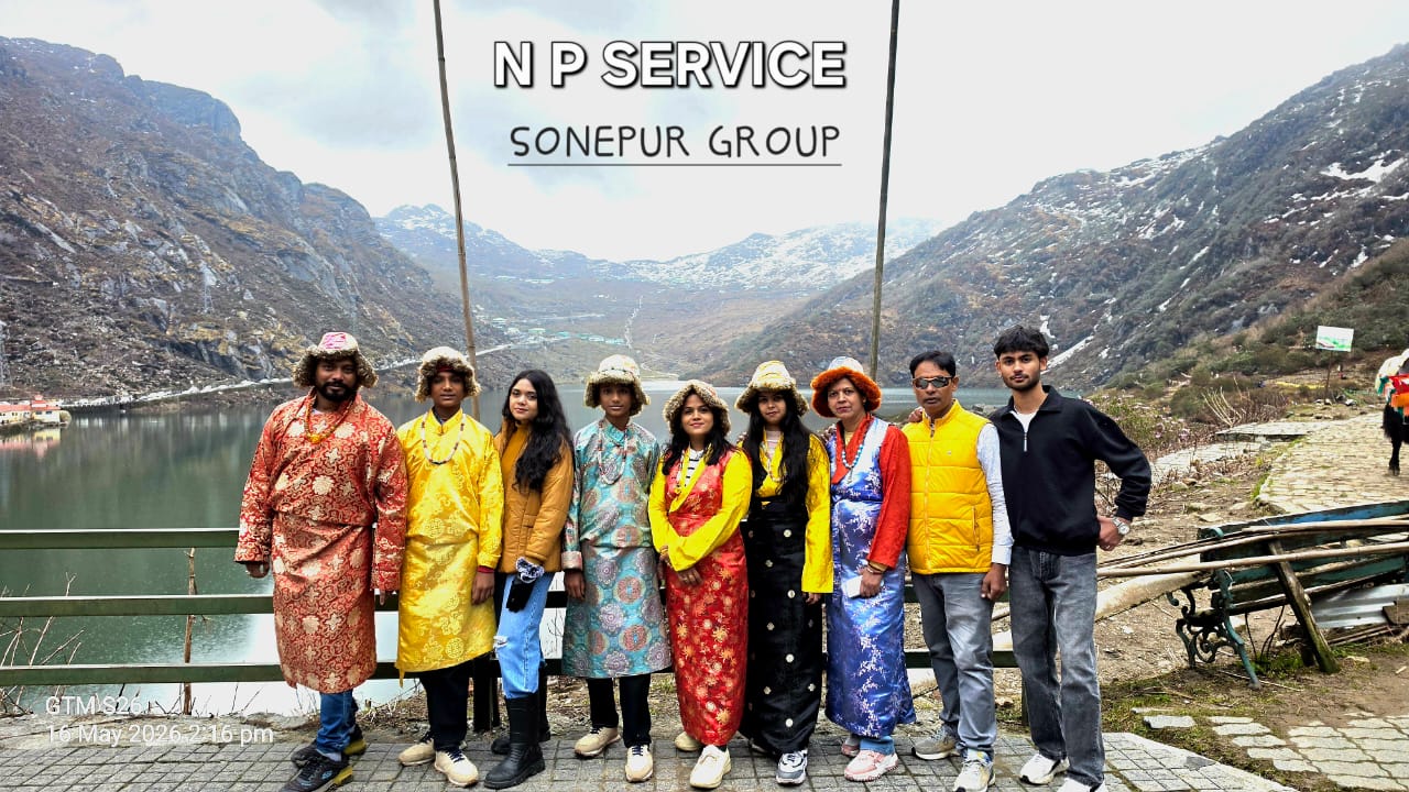 Travellers posing beside a mountain lake with an NP Service tour banner