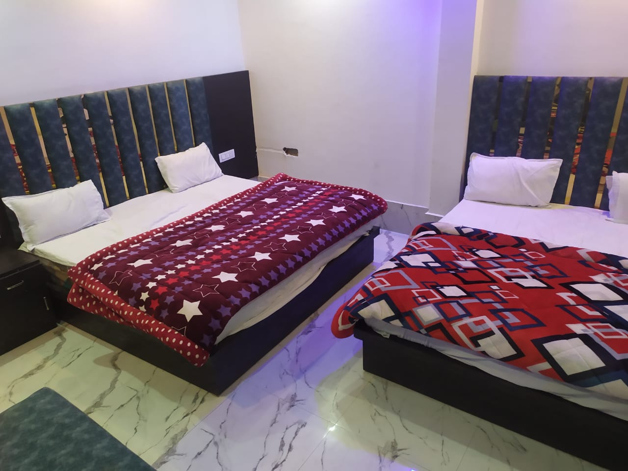 A twin-bed room with neatly arranged bedding